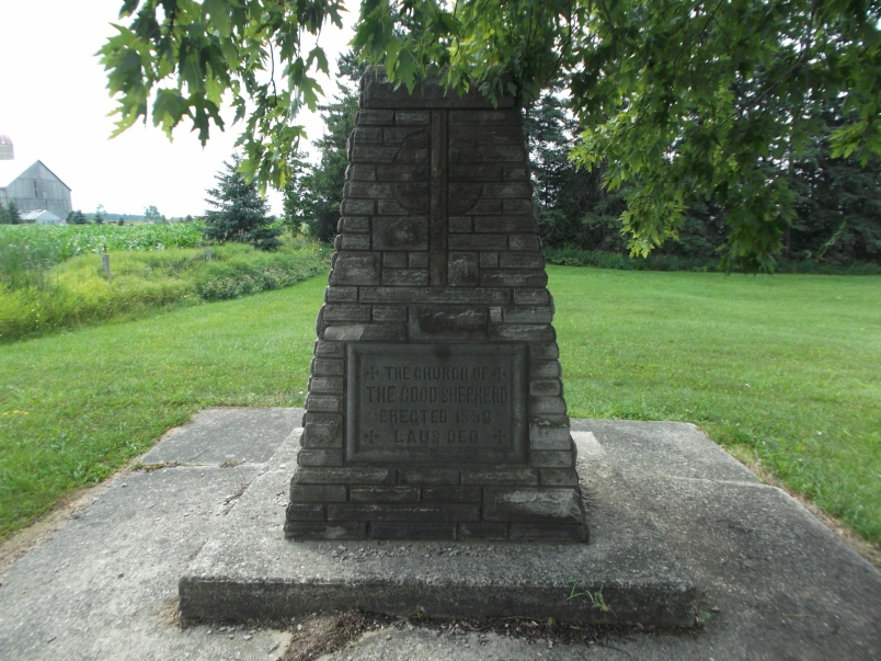 Picture of a cement plaque on the cairn in the cemetery